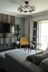 a living room with a couch and a tv at The View - Luxury Apartment in eMalahleni