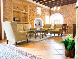 a living room with chairs and a table at Hotel Rural Son Terrassa in Caʼs Concos