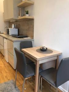 a small kitchen with a wooden table and chairs at Diamond in Budapest