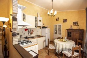 a kitchen with a table and a stove top oven at Relax nell' Antico Borgo in Casperia