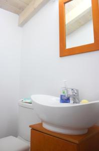 a bathroom with a white sink and a mirror at EVANNA HOUSE in Symi