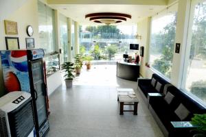 a lobby of a store with a couch and a table at Hotel Rani Bagh Resort in Beāwar
