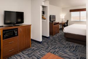 a hotel room with a bed and a flat screen tv at Holiday Inn Express & Suites Alamogordo Highway 54/70 by IHG in Alamogordo