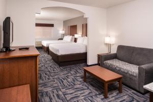 a hotel room with a bed and a couch at Holiday Inn Express & Suites Alamogordo Highway 54/70 by IHG in Alamogordo