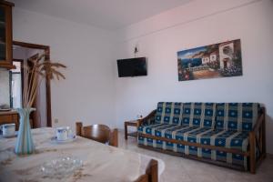 a living room with a couch and a table at Maxis apartment 2 in Koroni