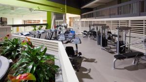 a gym with a row of treadms and machines at Holiday Inn Burlington Hotel & Conference Centre, an IHG Hotel in Burlington