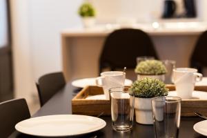 a table with white plates and glasses on it at Smartflats - Bourse Brussels in Brussels