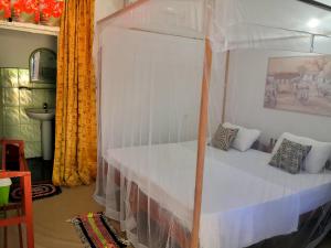 a bedroom with a bunk bed with white sheets at Star Rest Beach Hotel in Arugam Bay