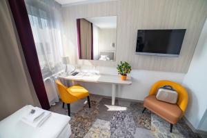 a hotel room with a sink and a mirror at Hotel Victoria in Lublin