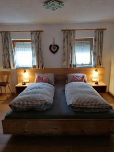 a bedroom with a bed with two pillows on it at Spatenhof in Fügenberg