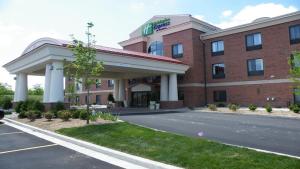 a hotel with a parking lot in front of it at Holiday Inn Express Hotel & Suites Lansing-Dimondale by IHG in Dimondale