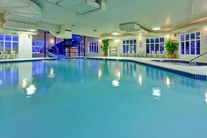 a swimming pool with a slide in a building at Holiday Inn Express Airdrie, an IHG Hotel in Airdrie