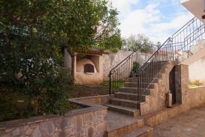 a set of stairs leading up to a building at Maxis apartment 4 in Koroni
