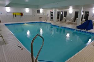a large swimming pool with blue water in a building at Holiday Inn Express & Suites Monroe, an IHG Hotel in Monroe