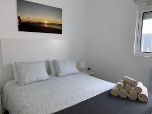 um quarto com uma cama com duas almofadas e uma televisão em TangoSierraResidences em Alcochete