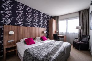 
a bedroom with a large bed and a large window at Martini Hotel in Groningen
