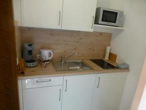 Kuchyň nebo kuchyňský kout v ubytování BIT-City Studio und Appartement