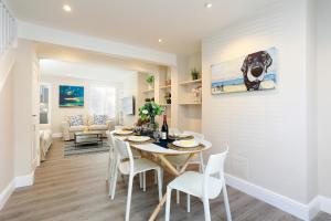 a dining room and living room with a table and chairs at No 10 in Whitstable
