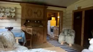 a kitchen with a dog sitting in the doorway at Brekkøye i Lom in Lom