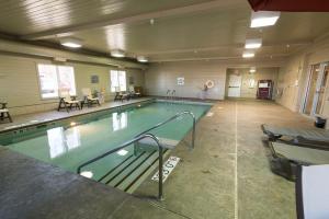 a pool in a building with a lot of floor space at Holiday Inn Express & Suites Iron Mountain, an IHG Hotel in Iron Mountain