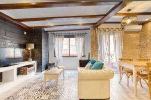 a living room with a couch and a table at My Loft 4 You Sorolla in Valencia