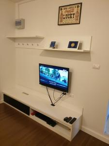 a flat screen tv sitting on a white entertainment center at The Relaxing Room Mountain View at Baan Tew Lom Condominium Cha Am - Hua Hin in Cha Am