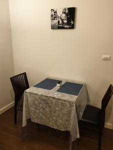 a table and two chairs and a picture on the wall at The Relaxing Room Mountain View at Baan Tew Lom Condominium Cha Am - Hua Hin in Cha Am