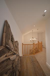 a living room with a chandelier on the wall at Lakeside Old Hunstanton in Hunstanton