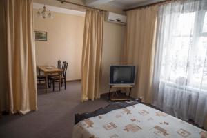 Televízia a/alebo spoločenská miestnosť v ubytovaní Chisinau Hotel
