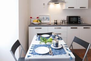 a kitchen with a table with plates on it at IL PORTICCIOLO in Riomaggiore +8 photos