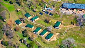 an aerial view of a farm house with several reservoirs at CBB - Camp Bir Billing in Bīr