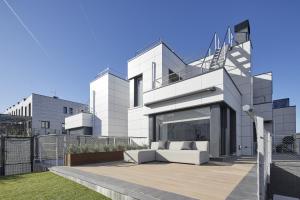 a modern house with a white couch on a patio at Villa Alimar - Basque Stay in San Sebastián