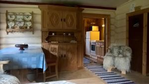 a kitchen with a dog sitting next to a table at Brekkøye i Lom in Lom