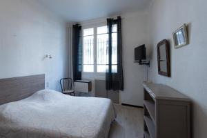 Кровать или кровати в номере T1 Rue CASTELLANE