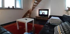 Posezení v ubytování Appartement Duplex à l'entrée de Ciney Avec emplacement vélos
