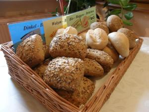 
a basket filled with lots of different types of bread at Hotel Schlossgarten in Neustrelitz
