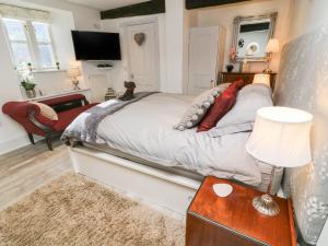 Voodi või voodid majutusasutuse Blacksmith Cottage toas