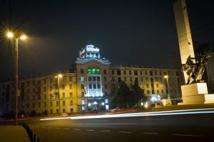 a building with green lights on top of it at night at Chisinau Hotel in Chişinău