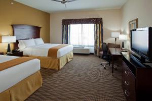 a hotel room with two beds and a flat screen tv at Holiday Inn Express & Suites Austin South-Buda by IHG in Buda +23 photos