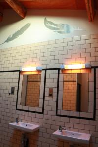 a bathroom with three sinks and two mirrors at The Liverpool Pod Travel Hostel in Liverpool