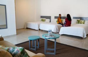 Postel nebo postele na pokoji v ubytování Hotel & Suites Arges - Centro Chetumal