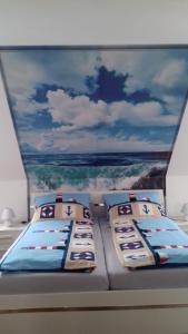 a bed on a boat with pillows on it at Am Park 2 in Wendtorf
