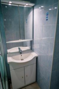 a bathroom with a sink and a mirror at Le Refuge in Lamoura