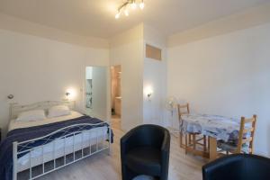 a bedroom with a bed and a table and chairs at T1 Rue CASTELLANE in Amélie-les-Bains-Palalda