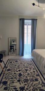 a bedroom with a bed and a large window at La stanza di Camillo in Rome