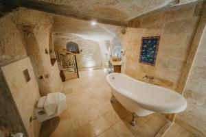 a bathroom with a sink and a bath tub at Erenbey Cave Hotel in Göreme