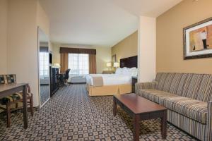 a hotel room with a bed and a couch at Holiday Inn Express & Suites Clovis, an IHG Hotel in Clovis