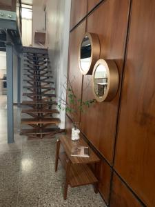 a room with a wooden wall with a table and a staircase at Hotel Residencia del Sol in Guatemala