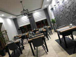 a restaurant with tables and chairs in a room at Alabastro in Tomaszów Mazowiecki