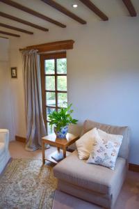 a living room with a couch and a window at Norfolk Broads Bolthole in Stokesby